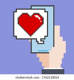 Pixel hand holding smartphone with like message.Vector illustration of hand holding smartphone with pixel art heart icon.