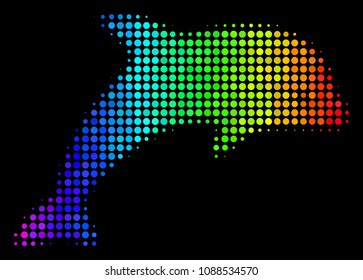 Pixel impressive halftone dolphin icon using spectral color tones with horizontal gradient on a black background. Colored vector mosaic of dolphin illustration composed from round dots.