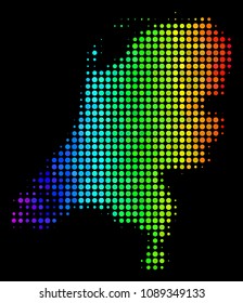 Pixel Netherlands map. Halftone geographic scheme drawn with spectrum color tints with horizontal gradient on a black background. Vector pattern of Netherlands map made of circle items.