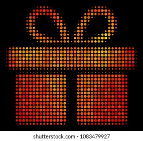 Pixelated gift icon. Bright pictogram in orange color tinges on a black background. Vector halftone pattern of gift pictogram composed with circle points.