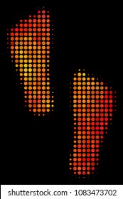 Pixelated human footprints icon. Bright pictogram in hot color variations on a black background. Vector halftone composition of human footprints icon done from circle points.