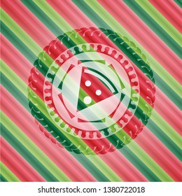 pizza slice icon inside christmas colors badge.