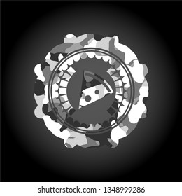 pizza slice icon inside grey camouflaged emblem