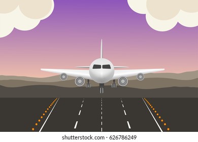 the plane comes in to land at sunset