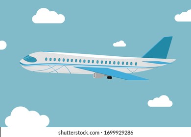 The plane flies among the clouds. Modern detailed airplane flying through clouds in the blue sky.