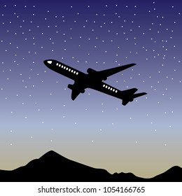 plane flying at night over the mountains