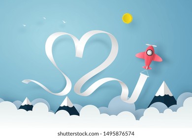 Plane flying on the blue sky over the clouds and mountain with smoke, heart ribbon in vector paper art concept