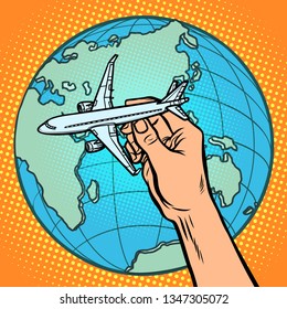 plane in hand. metaphor of flight to the Eastern hemisphere. Comic cartoon pop art vector retro vintage drawing