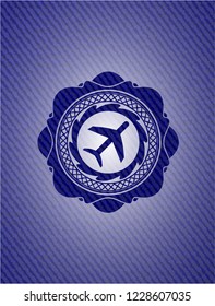 plane icon inside badge with denim texture