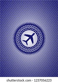 plane icon inside badge with denim background