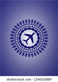 plane icon inside badge with denim background