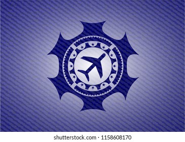 plane icon inside badge with jean texture
