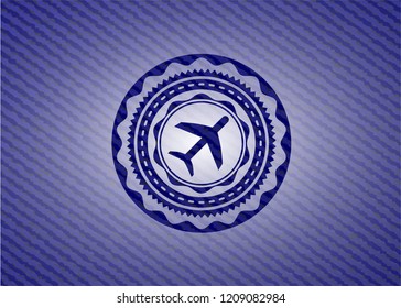 plane icon inside badge with jean texture