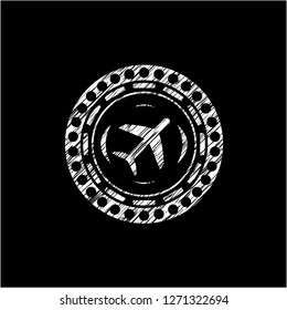 plane icon inside chalk emblem written on a blackboard