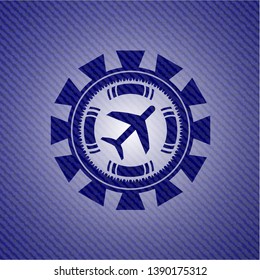 plane icon inside emblem with denim texture