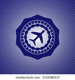 plane icon inside emblem with jean texture. 