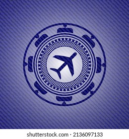 plane icon inside emblem with jean texture. 