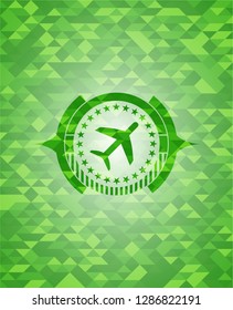 plane icon inside green emblem. Mosaic background