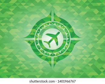 plane icon inside green mosaic emblem