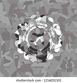 plane icon inside grey camouflage emblem