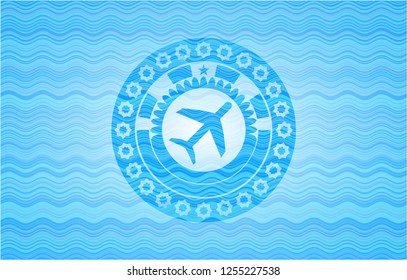 plane icon inside light blue water wave badge.
