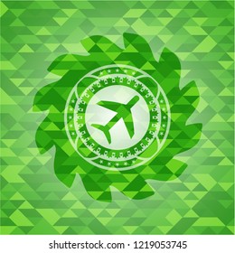 plane icon inside realistic green mosaic emblem