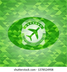 plane icon inside realistic green emblem. Mosaic background