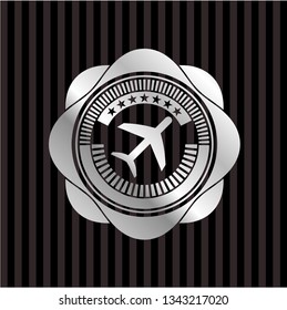 plane icon inside silver emblem or badge