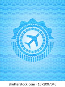 plane icon inside sky blue water wave style badge.