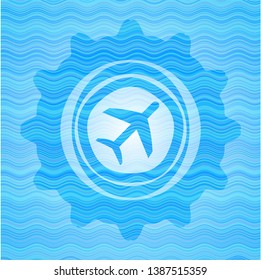 plane icon inside sky blue water wave emblem.