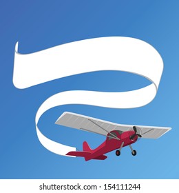 plane pulling white banner on the background of clear sky