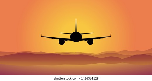 the plane at sunset flies into the sky. the plane is visible from the rear. below the mountains and the sea.