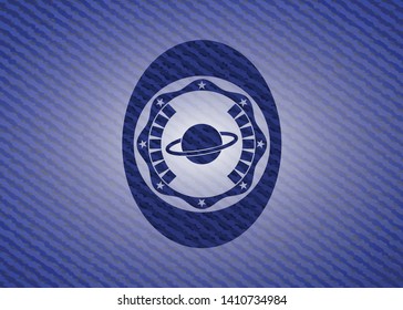 planet, saturn icon inside badge with denim texture