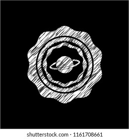 planet, saturn icon inside chalkboard emblem written on a blackboard