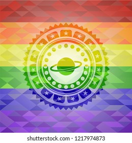 planet, saturn icon inside emblem on mosaic background with the colors of the LGBT flag