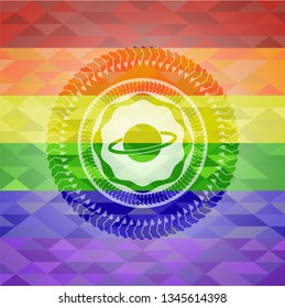 planet, saturn icon inside emblem on mosaic background with the colors of the LGBT flag