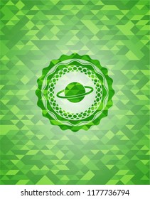 planet, saturn icon inside green emblem with triangle mosaic background