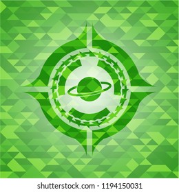 planet, saturn icon inside green emblem. Mosaic background
