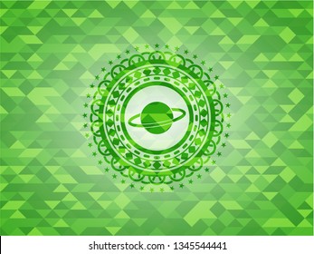 planet, saturn icon inside green emblem. Mosaic background