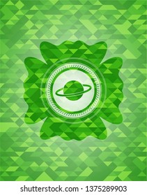 planet, saturn icon inside green emblem with mosaic background