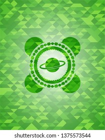 planet, saturn icon inside green emblem with triangle mosaic background
