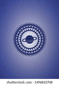 planet, saturn icon inside jean or denim emblem or badge background