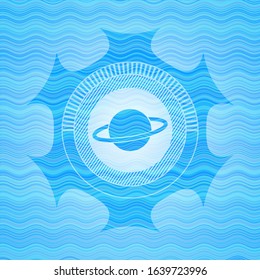 planet, saturn icon inside light blue water wave emblem.