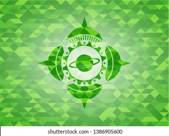 planet, saturn icon inside realistic green emblem. Mosaic background