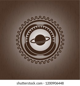 planet, saturn icon inside wooden emblem