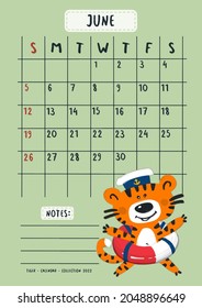 Planner calendar for June 2022. Cute tiger cub in the form of a sailor with a life buoy.