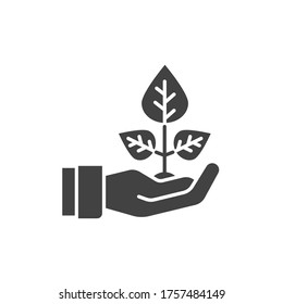 Plant based black glyph icon. Label for cosmetic natural product sign. Hand holding herb. Environment protect. Pictogram for web page, mobile app, promo. UI UX GUI design element