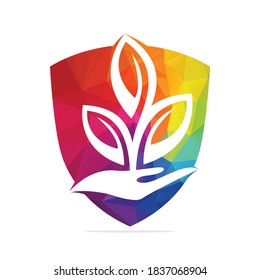 Plant in Hand Vector Logo Design. Natural Products in Shield Shape. Cosmetics and Spa logo.