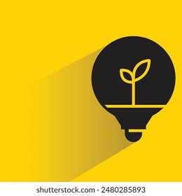 plant in light bulb with drop shadow on yellow background