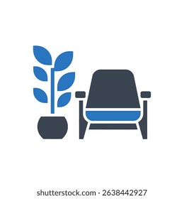 A plant in a pot beside a chair.